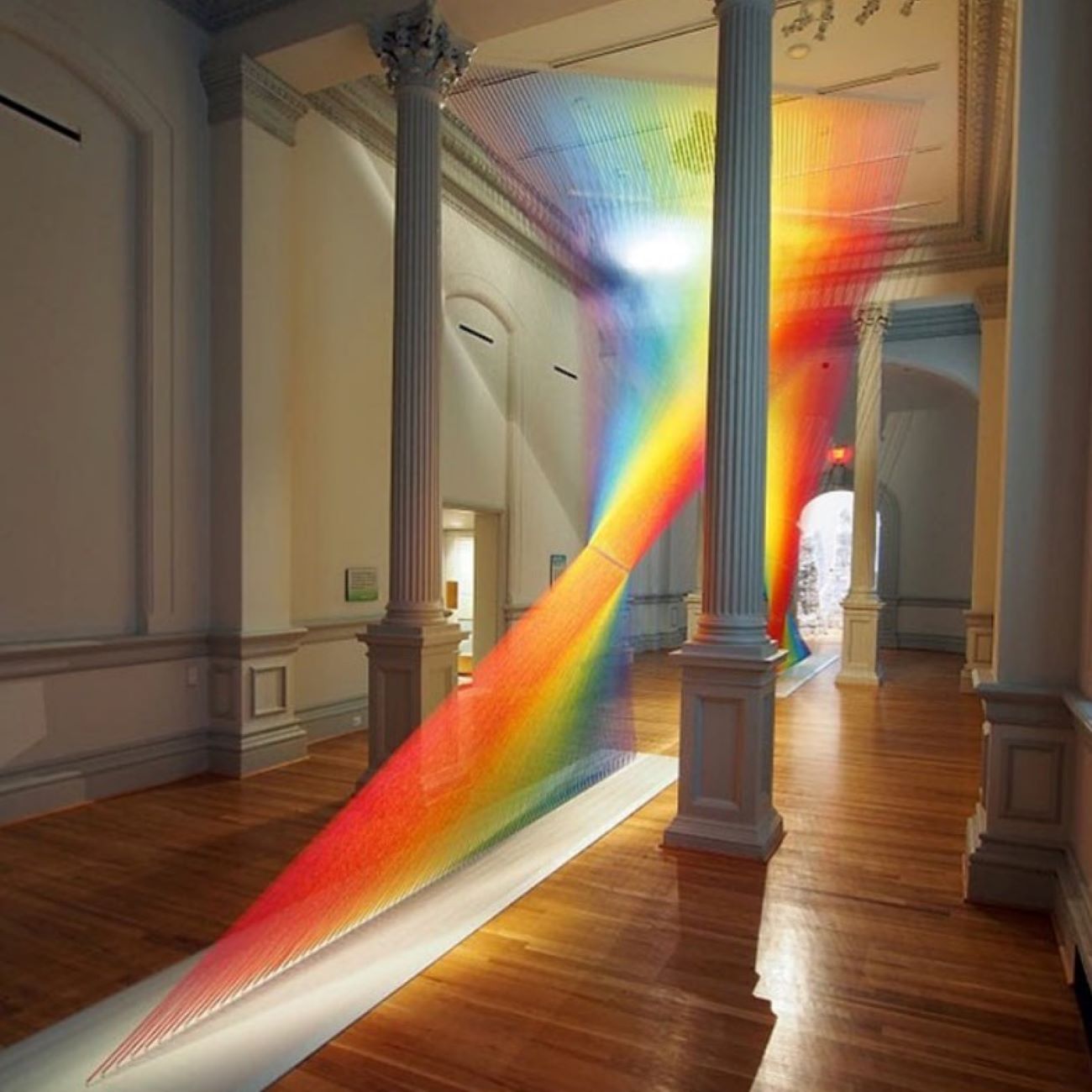 The Renwick Gallery, showcasing its historic architecture with grand columns and a rainbow art exhibit.