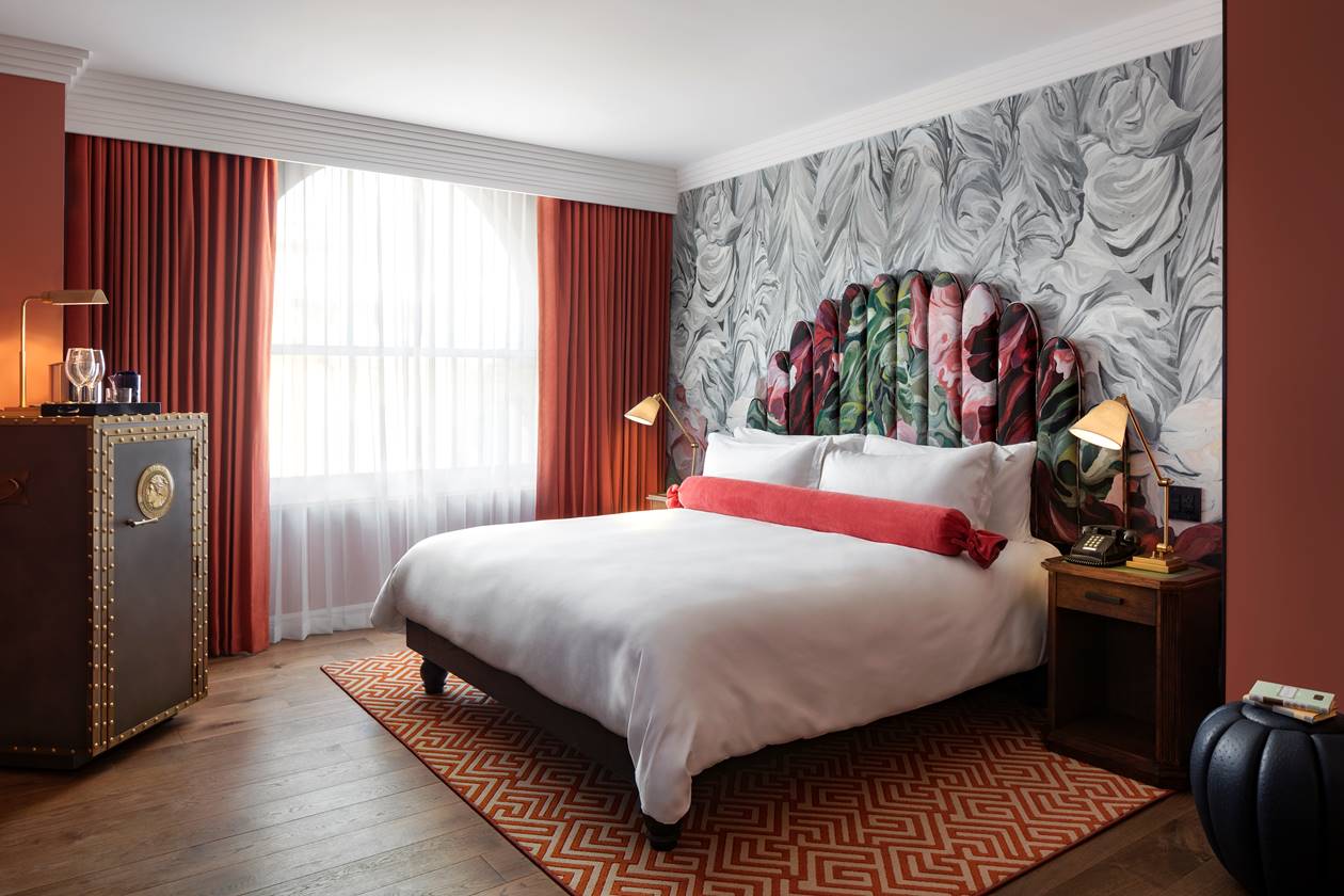 Standard room at Riggs DC featuring a bed, modern decor, and natural light, offering a cozy and inviting space